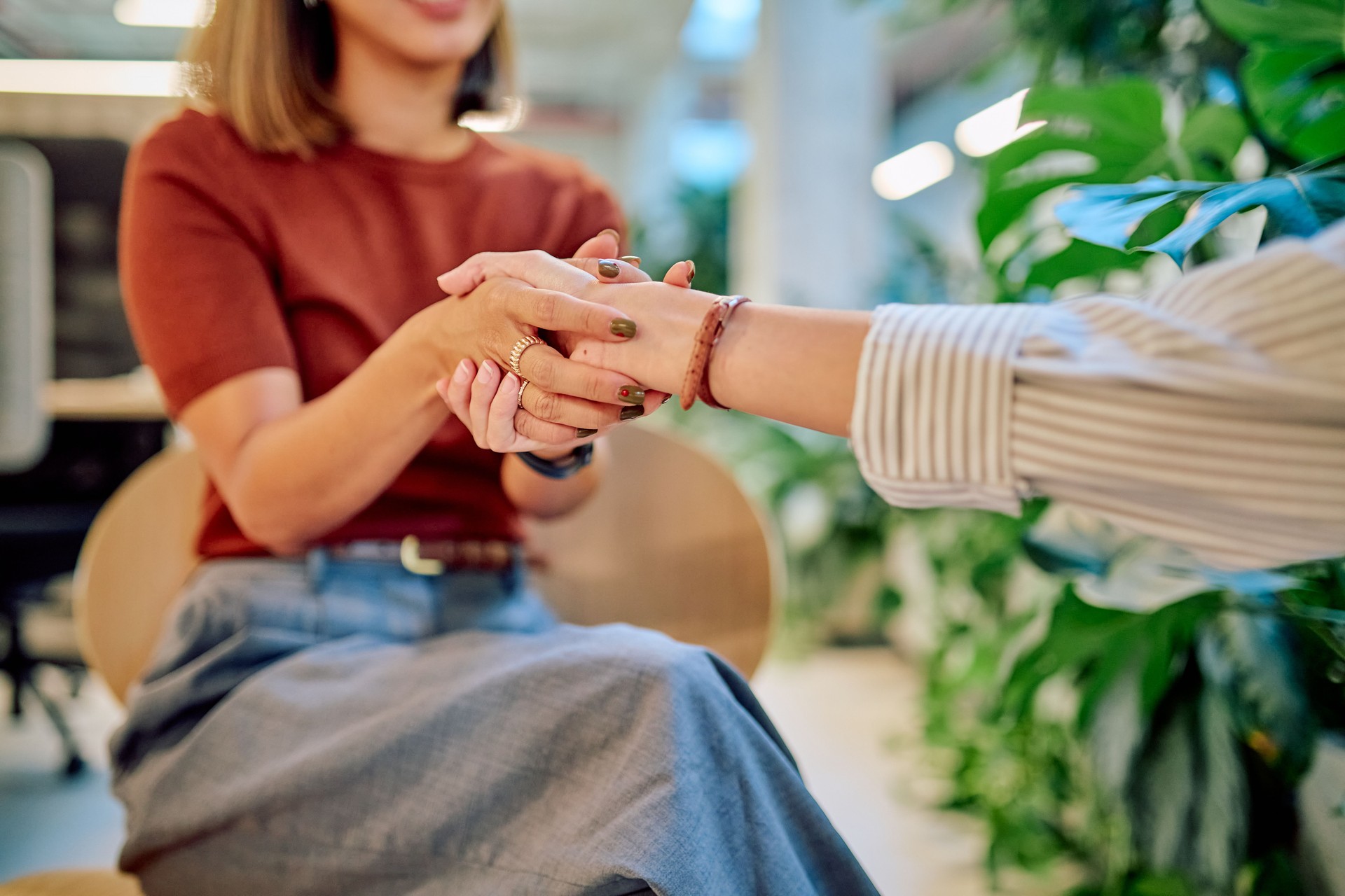 Psychologist holding hands of patient during therapy session